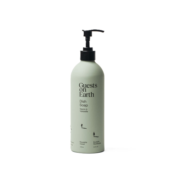 The Guests on Earth Dish Soap in pastel green features a black pump, minimalist black text, and small icons. Its concentrated formula creates a Citrus Oasis scent, while the refillable design emphasizes sustainability with every use.