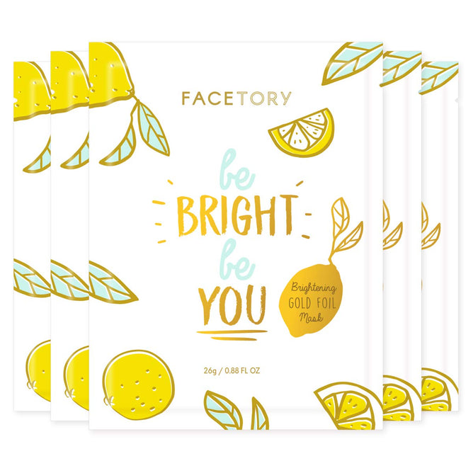 The packaging of the Be Bright Be You BRIGHTENING Sheet Mask by FaceTory features lemon and lime illustrations with leaf motifs. The text highlights its lemon extract and vitamin C content, packaged as a gold foil mask weighing 26g / 0.88 FL OZ.