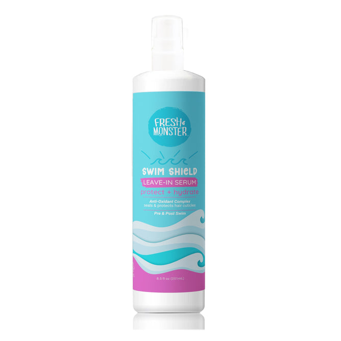 A bottle of Fresh Monster Swim Shield Protective Leave-in Serum with a white pump top features a blue and pink wave-design label, highlighting its chlorine protection and hair hydration benefits as a swim hair protector.