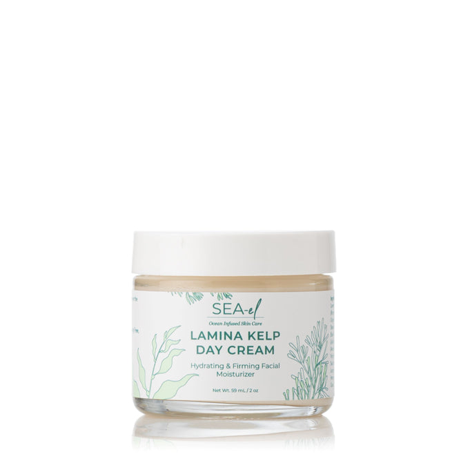 A glass jar of Sea-el Lamina Kelp Day Cream with a white lid, featuring green botanical illustrations. This hydrating and firming moisturizer locks in moisture. Net weight: 59 ml (2 oz).