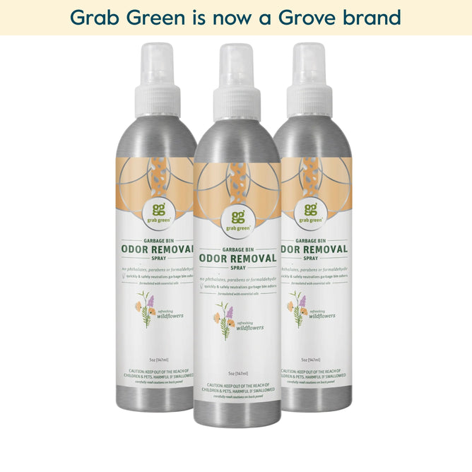 Three bottles of grab green Garbage Pail Odor Removal Spray - 3 Pack - Wild Flowers (Coming Soon!) are displayed side by side with silver tops and white labels. A banner above says, grab green is now a Grove brand.