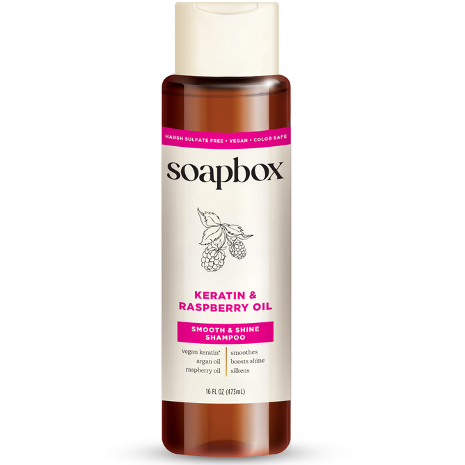 Soapboxs Vegan Keratin & Raspberry Seed Oil Smoothing Shampoo comes in a 16 fl oz (473ml) bottle, featuring a 5X vitamin complex. Its marketed as sulfate-free, color-safe, and vegan keratin-infused to enhance shine, smoothness, and silkiness.