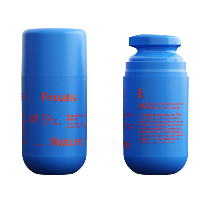 Two blue cylindrical bottles of Freaks of Natures Daily Defender SPF30 Sunscreen, featuring bright red text, are displayed. One bottle has its cap on, while the other reveals a pump. This broad-spectrum formula offers added protection with pollution-repelling vegan spider silk protein.
