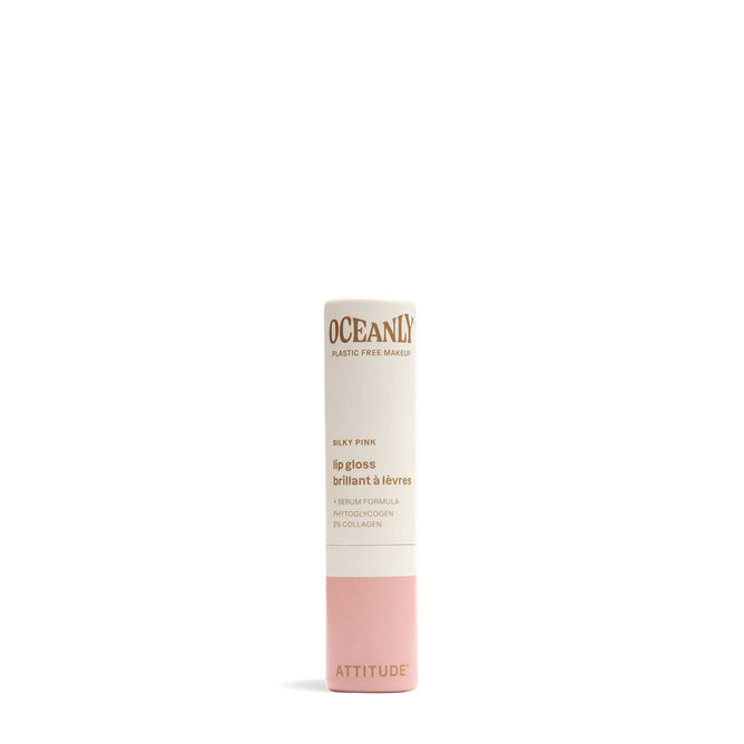 A tube of Oceanly Lip Gloss by ATTITUDE, crafted with naturally sourced ingredients in a vegan, cruelty-free formula and silky pink shade. Features minimalist white and pink design with gold and pink text.