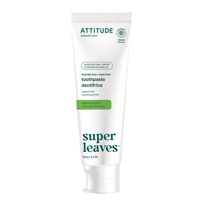 A white tube of ATTITUDE super leaves Fluoride-free Toothpaste - Fresh Breath, labeled vegan and peppermint flavor, with green accents. Made with 98.5% natural ingredients for fresh breath without fluoride.
