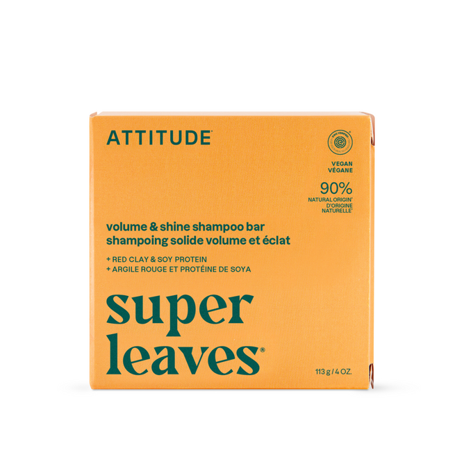 An orange box of ATTITUDE super leaves Shampoo Volume & Shine with red clay and soy protein. This vegan shampoo contains 90% natural ingredients and plant-powered formula for voluminous, shiny hair.