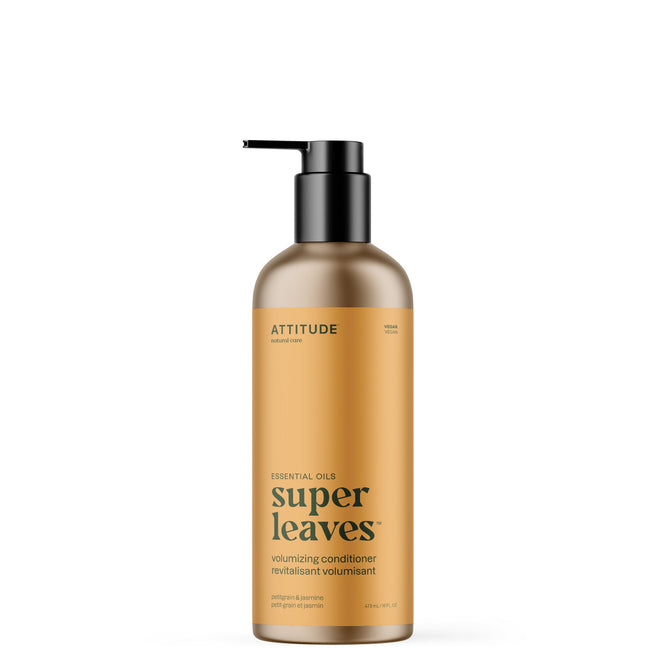 A gold bottle of ATTITUDE super leaves essential oils Conditioner Volumizing with a black pump features English and French labels highlighting “Naturally Sourced Ingredients,” “Essential Oils,” and “vegan”—with Petitgrain & Jasmine.