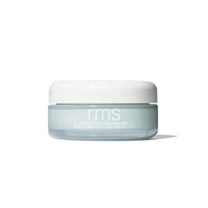 A light blue jar with a white lid labeled RMS Beauty Coconut Clean Cleansing Balm, renowned for clean beauty and gentle makeup removal, sits on a white background.