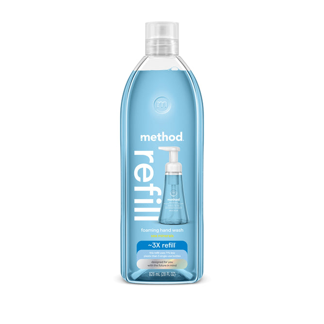 A clear plastic bottle of method Foaming Hand Soap Refill with blue liquid inside. The label highlights pink grapefruit refill, features a soap dispenser, and notes it’s made from recycled plastic for three refills.