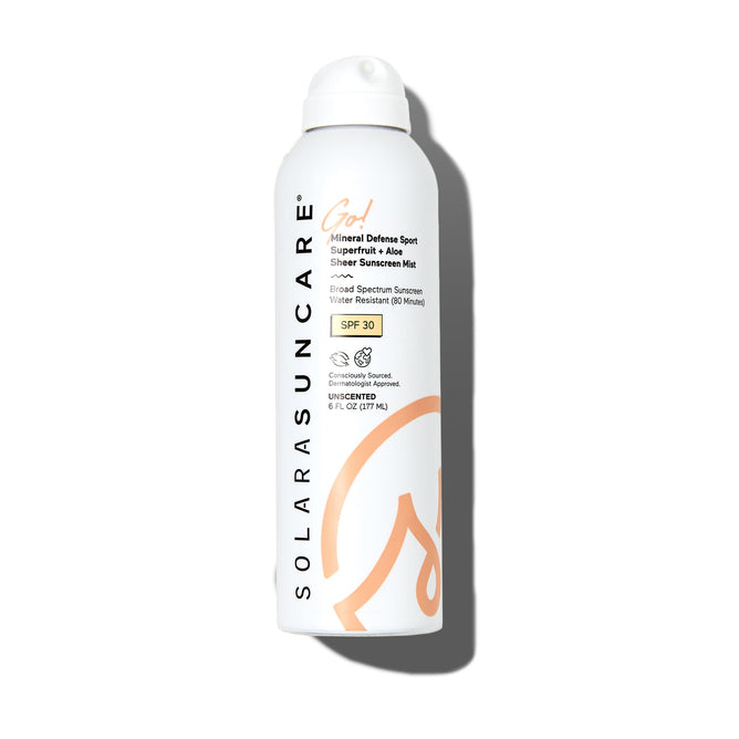 A white spray bottle of Solara Suncare Go! Mineral Defense Sport: Superfruit + Aloe Mist SPF 30 with orange accents, highlighting its water resistance, broad-spectrum protection, and unscented formula on the front.