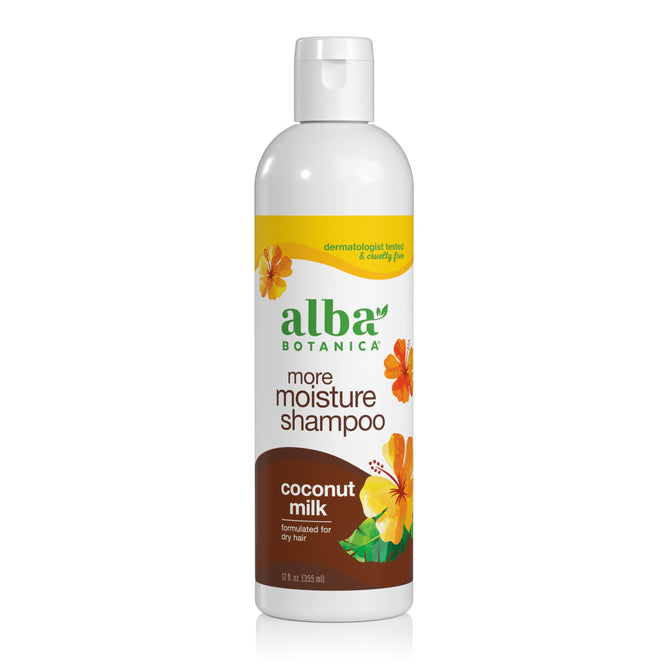 A white bottle of Alba Botanica More Moisture Coconut Milk Shampoo, a sulfate-free formula for mega moisture, with orange and yellow hibiscus flowers and green leaves on the label.