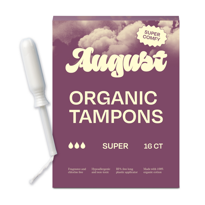 A box of August Super Tampons, featuring organic cotton and a BPA-free plastic applicator, sits beside its purple packaging with cream text reading August Organic Tampons, Super, 16 CT, Super Comfy.