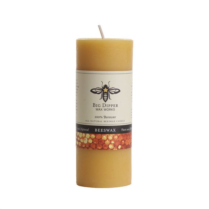 The Big Dipper Wax Works 100% Pure Beeswax Pillar Candle Natural is a tall, cylindrical yellow candle with a white wick and bee label, providing an eco-friendly, toxin-free option for your home.