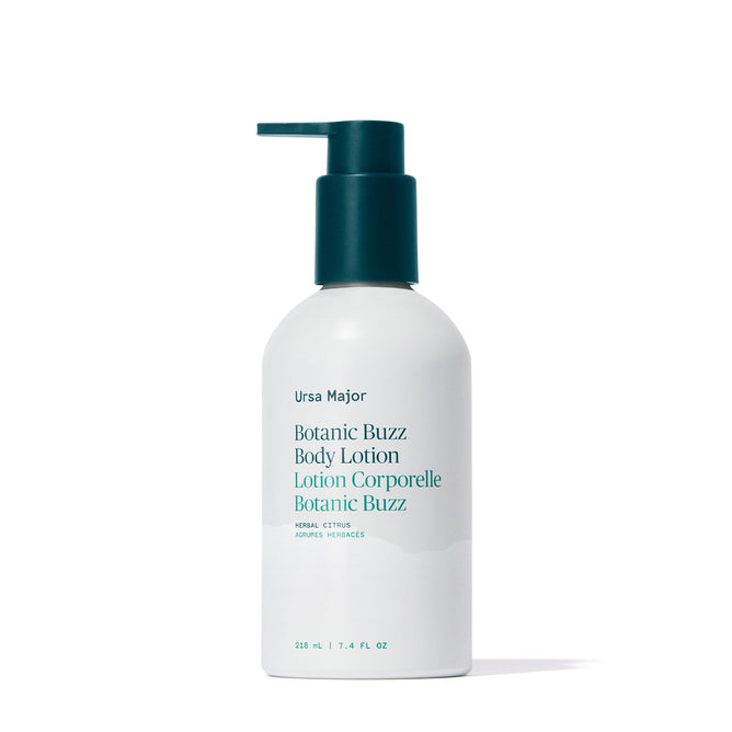 A white bottle of Ursa Major Botanic Buzz Body Lotion with a teal pump. The label shows the product name and details in blue and teal text.