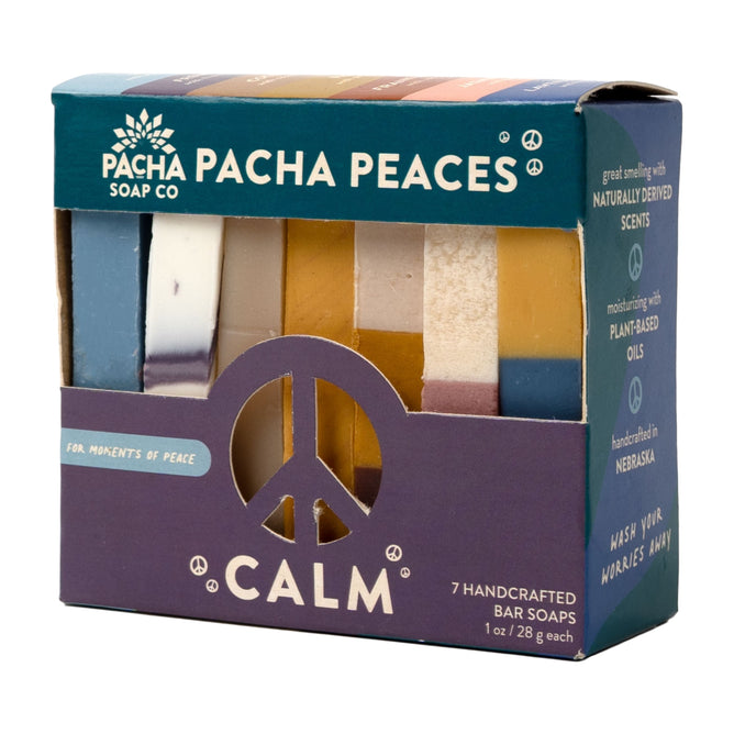 The Pacha Soap Co. Bar Soap, Pacha Peaces variety pack features seven best-selling handcrafted soaps in assorted colors, displayed in a box with a peace symbol cutout on the front.