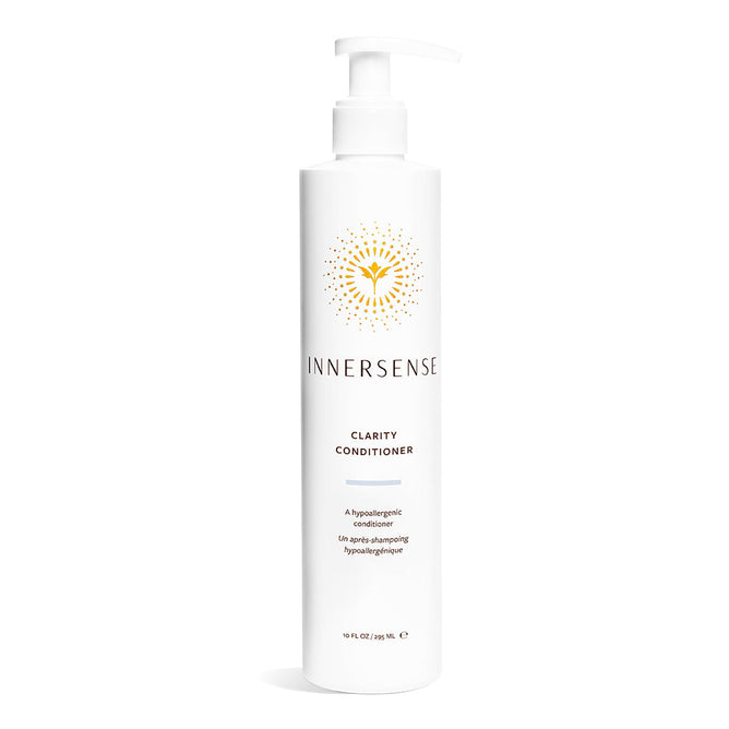 A white bottle of Innersense Organic Beauty Clarity Conditioner with a pump top, gold sunburst design, and brand text. The label highlights this hypoallergenic, silicone-free formula for sensitive scalps.