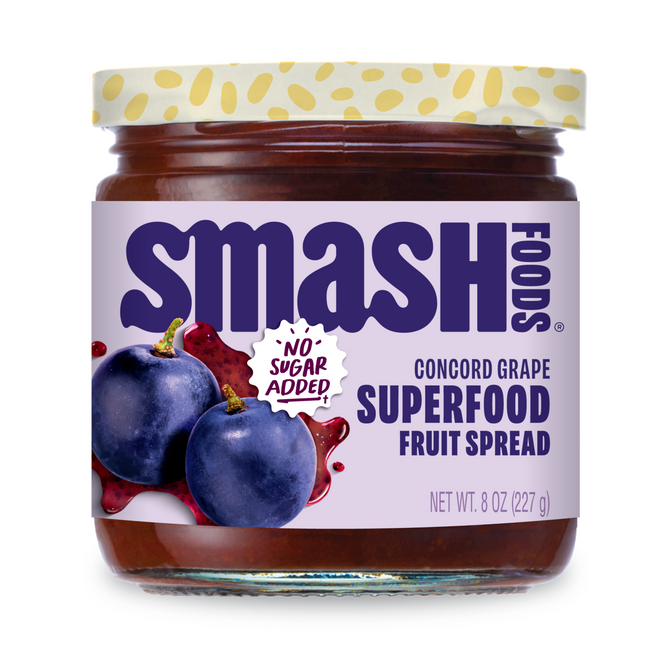 A jar of Smash Foods Superfood Jam - Raspberry with “No Sugar Added!” on the label. Naturally sweetened and packed with superfoods, it has a yellow polka-dotted lid and weighs 8 oz (227 g).