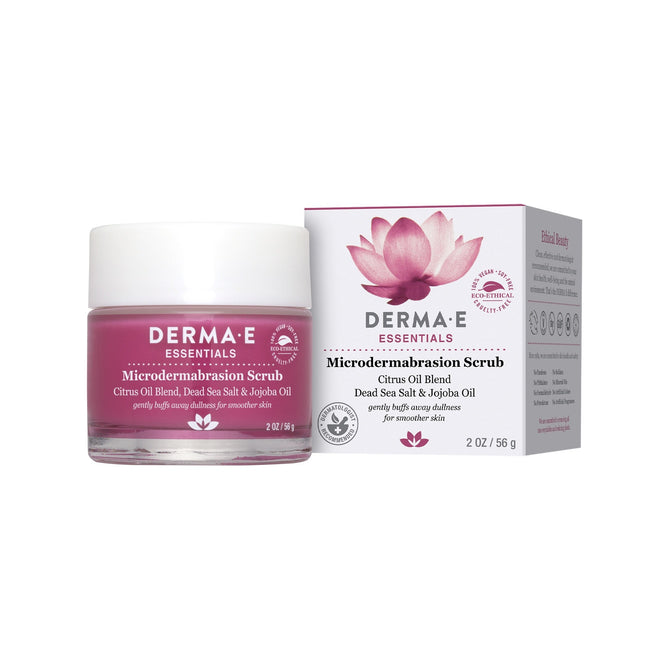A dermatologist-recommended, pink jar of Derma Es Microdermabrasion Scrub with fine crystals and citrus oil is shown alongside its box featuring a lotus design and detailed product info.