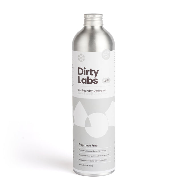 A metallic bottle of Dirty Labs Bio Laundry Detergent with Phytolase® - Free & Clear stands upright. The label is white with gray text, emphasizing its fragrance-free formula and effective stain removal, ideal for sensitive skin.