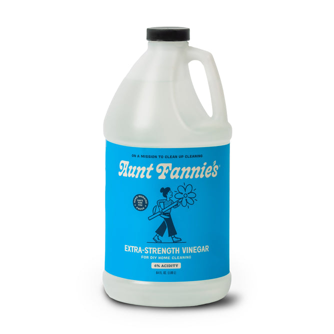 Aunt Fannie’s Extra Strength Cleaning Vinegar, Refill (6% acidity), comes in a clear plastic gallon jug with a blue label featuring a cartoon person holding a flower—ideal for home cleaning needs.