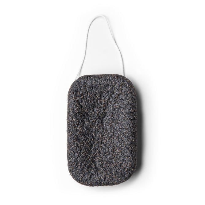 The Exfoliating Konjac Body Sponge by Everist is a rectangular black sponge with a rough texture, rounded corners, and a white hanging string, designed for exfoliating and detoxifying skin.