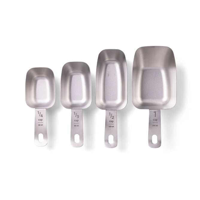 The Full Circle Measuring Cup Set includes four durable, sleek stainless steel cups ranging from 1/4 to 1 cup. Each has a long handle with clear measurements and a unique square design, combining practicality with modern style.