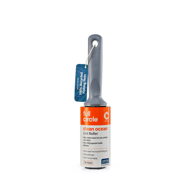 The Full Circle Clean Ocean Lint Roller features a gray handle made from repurposed ghost nets and an orange and white label. This eco-friendly lint roller is plastic-free and emphasizes sustainable qualities.
