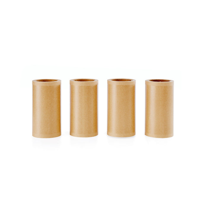 Four Clean Ocean Lint Roller Refill tubes from Full Circle, a 4-pack of eco-friendly brown cardboard refills, stand upright in a row on a white background.
