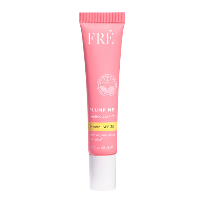 A pink tube of FRÉ Skincare PLUMP ME Peptide Lip Tint Mineral SPF 30 with white and yellow text, a white cap, and 0.51 fl oz (15 mL) inside.