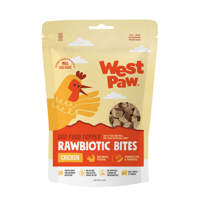 A beige and orange bag of West Paw Chicken Rawbiotic Bites Dog Food Topper features an illustrated chicken, product info, and visible brown bites made with premium raw animal proteins and fermented probiotics.