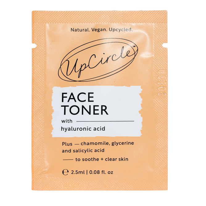 The UpCircle Face Toner - Sample is a 2.5ml orange packet with hyaluronic acid, chamomile, glycerine, and salicylic acid to soothe and clear skin. This vegan toner fits naturally into sustainable routines by incorporating upcycled ingredients.