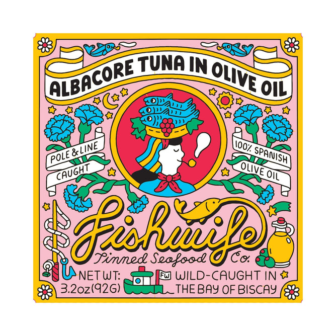 The Albacore Tuna in Olive Oil by Fishwife features a vintage-style label showing a female sailor with a fish hat and pipe amid fish, clouds, and olive branches. Its pole & line caught from the Bay of Biscay and perfectly crafted by an authentic Spanish cannery using 100% Spanish olive oil.