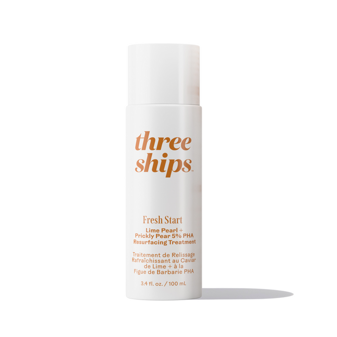 A white bottle labeled Three Ships Fresh Start Lime Pearl + Prickly Pear 5% PHA Resurfacing Treatment, with orange text, stands upright against a plain white background.