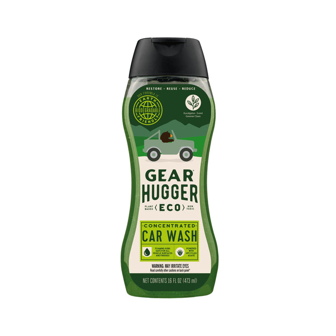 The 16 oz (473 ml) Gear Hugger Eco Car Wash bottle features eco-friendly icons and green vehicle graphics, emphasizing its bio-based ingredients and environmental benefits, along with usage instructions for its concentrated formula.