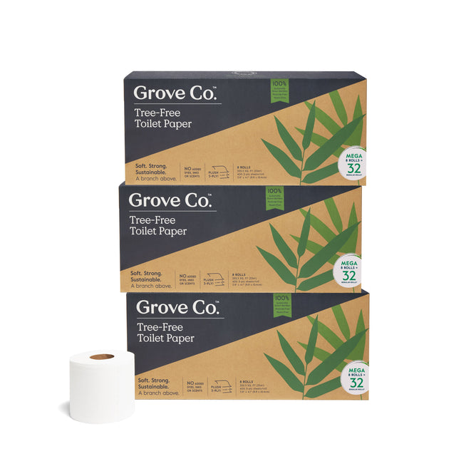 Stacks of Grove Co. 3-Ply Bamboo Toilet Paper packages, showcasing green leaf designs on brown boxes. Each box contains 32 mega rolls. One eco-friendly bamboo roll is displayed in front on the left.