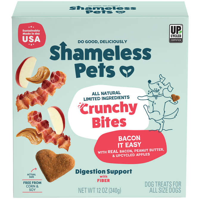 A box of Shameless Pets Bacon it Easy Crunchy Bites, all-natural dog treats with bacon, upcycled apple, and peanut butter, featuring a playful dog illustration on a teal background.