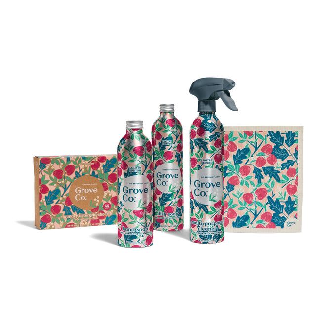 The Grove Co. Scent Essentials - Fall Collection features eco-friendly home products in colorful floral packaging, including a box, three bottles (one with a spray nozzle), and a cleaning cloth, all displayed on a white background.
