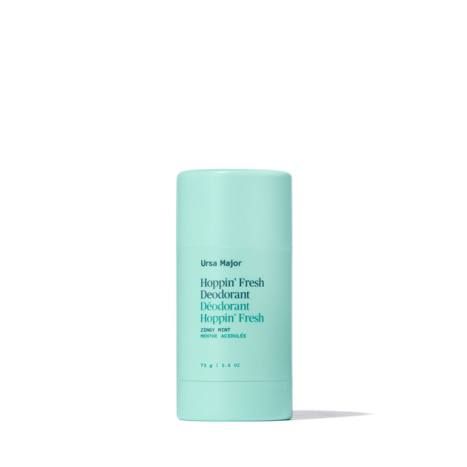 A stick of Ursa Major Hoppin Fresh Deodorant in light turquoise stands upright against a white background. The label reads Fresh Deodorant, Zesty Mint, 75 g | 2.5 oz. This natural deodorant features essential oils.