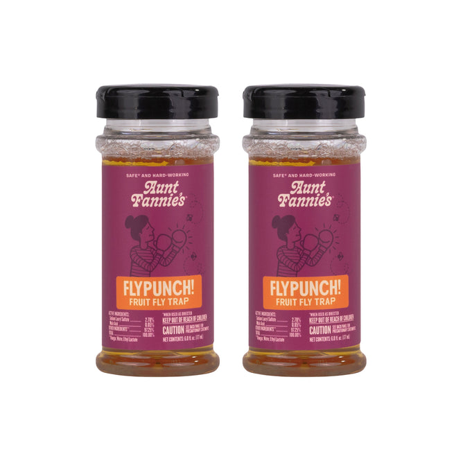 Two bottles of Aunt Fannies Buy 1 FlyPunch! Fruit Fly Trap, Get 1 Free with purple labels and black lids are shown side by side against a white background—a simple way to control fruit flies.