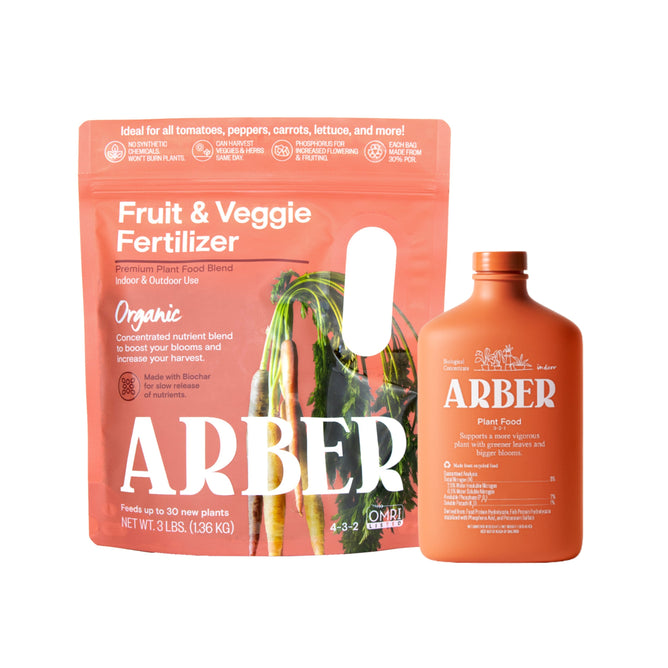 Arbers orange packaging for the Buy Organic Fruit & Veggie Fertilizer, Get Plant Food Concentrate Free features white text and illustrated carrots, and promotes organic care for tomatoes, peppers, carrots, lettuce, and more.