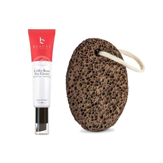 A tube of Beauty by Earths Coffee Bean Awakening Eye Cream, designed to reduce puffy eyes, sits beside a dark brown pumice stone with a white looped string as a free gift.