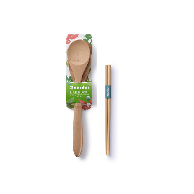 The Bambu Kitchen Basics Set of 3, plus a free gift, offers an elegant touch with its bamboo spoon in floral packaging and chopsticks featuring a blue band, highlighting natural sophistication against a white background.
