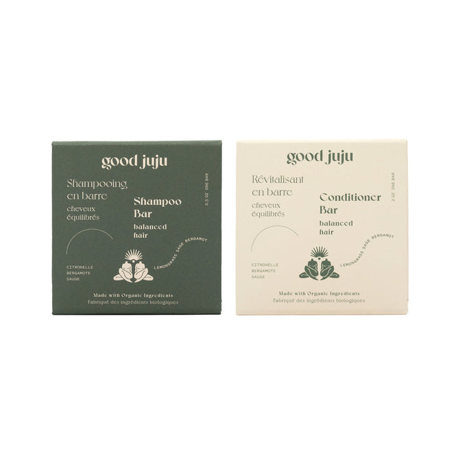 The Good Juju Body & Home Normal/Balanced Haircare Set includes a green Shampoo Bar and cream Conditioner Bar, both made with organic ingredients for balanced hair.