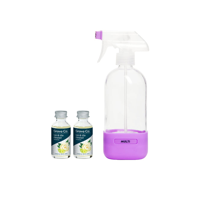 The Grove Collaborative Tub & Tile Cleaner Starter Set includes a reusable spray bottle with a purple base and trigger labeled “MULTI,” alongside two citron & white rose concentrate bottles with white caps and green labels.