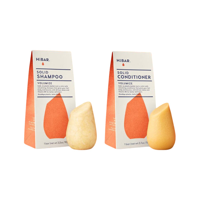 The HiBAR Volumize Haircare Set features the solid shampoo (left) and conditioner (right), each displayed before their matching orange and white packages on a white background.
