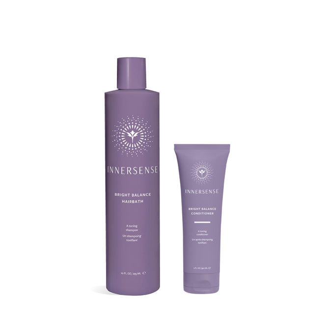 Two purple Innersense Organic Beauty products are shown: a tall bottle of Bright Balance Hairbath + free gift, with a vegan formula to neutralize brassiness, and a shorter tube of Bright Balance Conditioner. Both feature minimalistic white design with branding text.