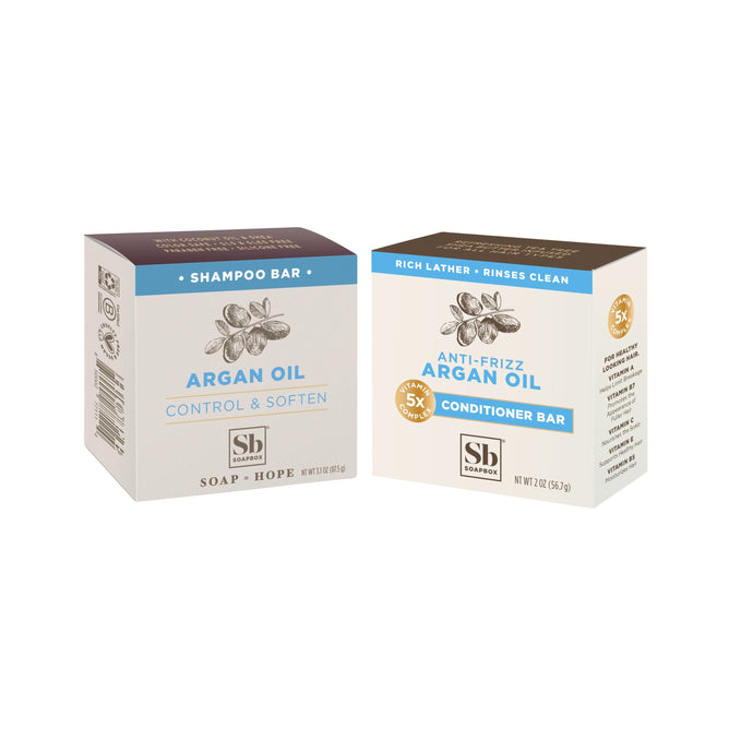Soapbox Moroccan Argan Oil Haircare Set: includes an Argan Oil Shampoo Bar (Control & Soften) and an Anti-Frizz Conditioner Bar, both in brown and cream packaging with argan illustrations.