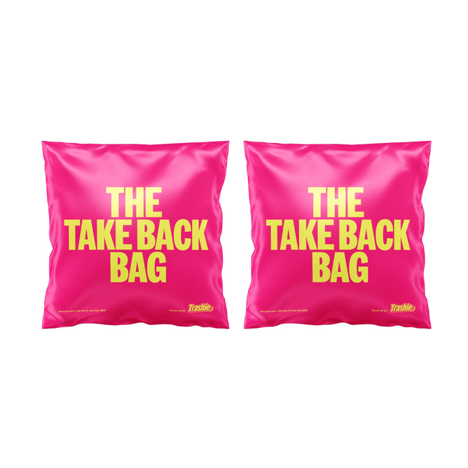 Two pink The Take Back Bag + free gift by Trashie feature bold yellow text, ideal for recycling clothes. Placed side by side on a white backdrop, these stylish bags offer an eco-friendly solution for sustainable fashion.