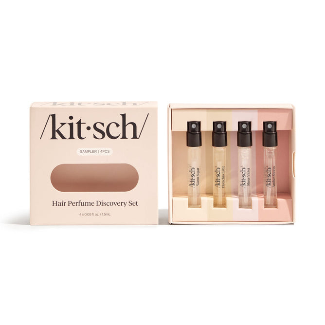 The Kitsch Hair Perfume Discovery Set includes four small spray bottles that refresh your hair using odor-eliminating technology, available in various scents. The beige box features the brand name Kitsch and labels it as a sampler set.