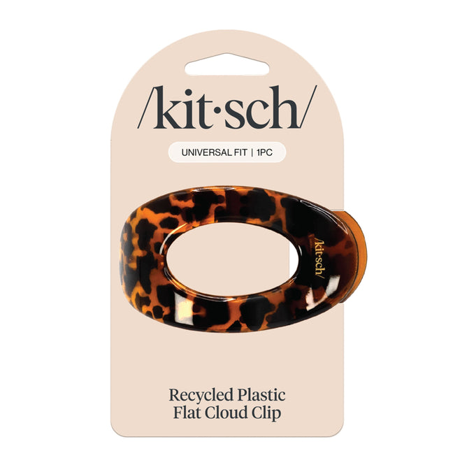 The Kitsch packaging for the Medium Flat Cloud Clip displays the brand name at the top, reads Universal Fit | 1 pc, and mentions Eco-friendly Recycled Plastic at the bottom. The oval clip features a chic tortoiseshell pattern for a stylish and sustainable choice.